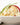 A photo of a Aussie coleslaw with carrot, cabbage, spring onions, red capsicum, and a creamy coleslaw dressing.