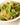 A photo of a Couscous and roasted sweet potato with pistachio, roquette, and green chilli.