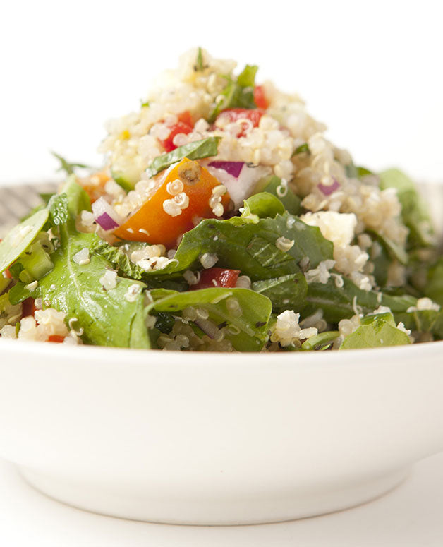 A photo of a Tangy quinoa salad with mint, fetta, tomatoes, and roquette. 