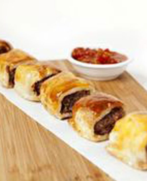A photo of An old favourite, large sausage roll made with sausage mince mixed herbs and onions.