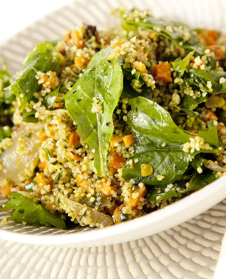 A photo of a Couscous and roasted sweet potato with pistachio, roquette, and green chilli. 